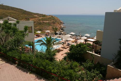 a view of a resort with a swimming pool and the ocean at Erytha Hotel & Resort Chios in Karfas