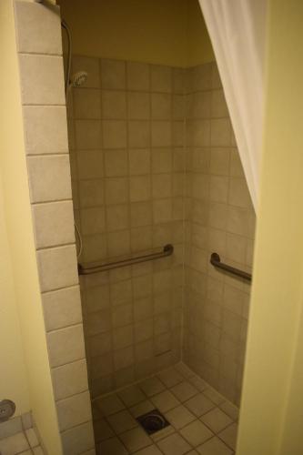 a bathroom with a shower with tiled floors at Baymont by Wyndham Yakima Riverfront in Yakima