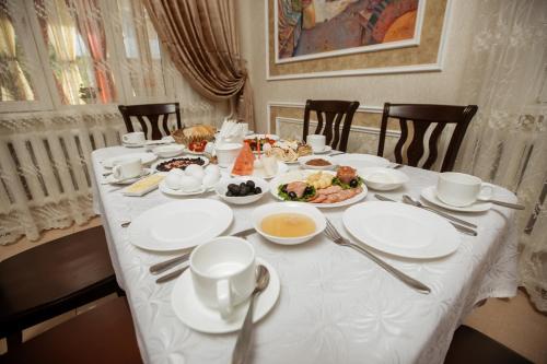 a table with plates and bowls of food on it at Hotel Asia Khiva in Khiva