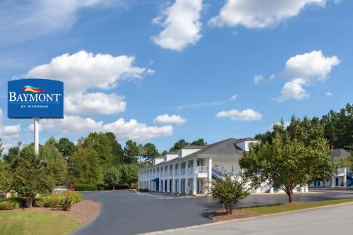 a sign in front of a building at Baymont by Wyndham Greenwood in Greenwood