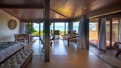 a bedroom with a view of the ocean at Hotel Sombra e Água Fresca in Pipa