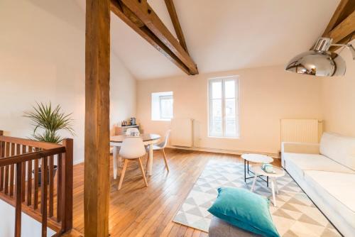a living room with a couch and a table at Newcenter Duplex in Auxerre
