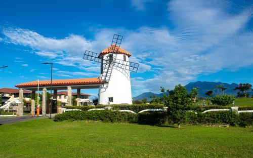 a white lighthouse in front of a building at Hacienda Los Molinos Boutique Hotel & Villas in Boquete