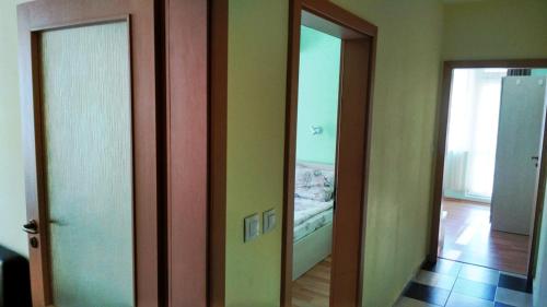 a hallway with two mirrors and a bed in a room at Darius HSTL in Sunny Beach