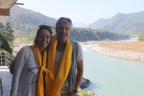 a man and a woman standing next to a river at Mansarover Home Stay in Kalimpong