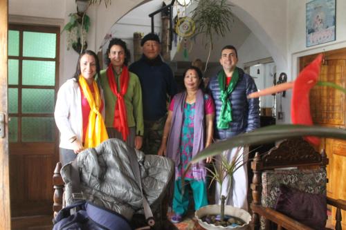 a group of people posing for a picture in a room at Mansarover Home Stay in Kalimpong