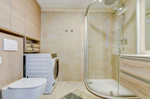 a bathroom with a toilet and a shower at City View Apartment 57 in Vilnius
