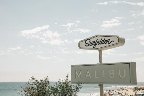 a sign for a mall in front of the beach at The Surfrider Malibu in Malibu