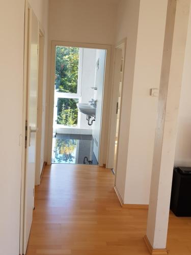 an empty hallway with a window and a sink at villa high ceiling 2 bedrooms in Troisdorf