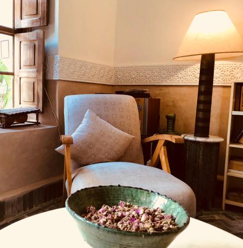 a room with a chair and a bowl on a table at Riad Le Coq Berbère in Marrakech