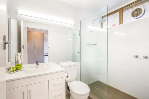 a bathroom with a toilet and a sink and a shower at Nightcap at Shoppingtown Hotel in Doncaster