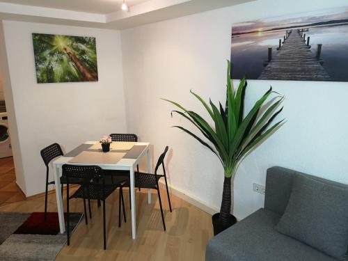 a dining room with a table and a plant at Sankt-Nikolaus Old Town Apartment in Innsbruck