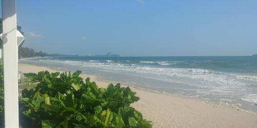 a view of a beach with the ocean at Khao Tao Beach Lodge Old Siam in Hua Hin