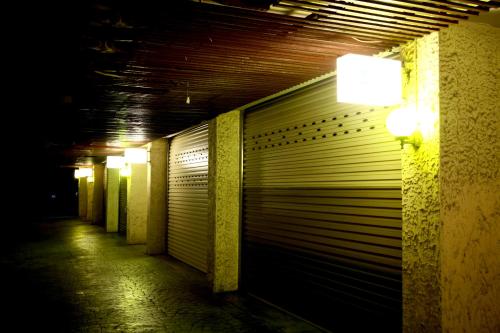 a dark hallway with a garage door and lights at Wen Mei Motel in Nantou City