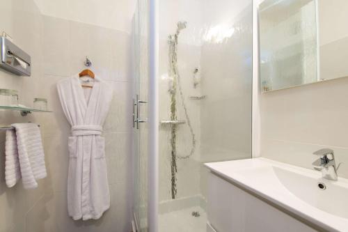 a white bathroom with a shower and a sink at Best Western Le Vinci Loire Valley in Amboise