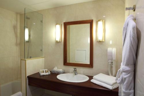 a bathroom with a sink and a mirror at Amiral Hôtel in Paris