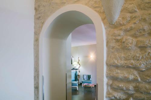 an archway in a room with a stone wall at Best Western Hotel du Roy d'Aragon in Bonifacio