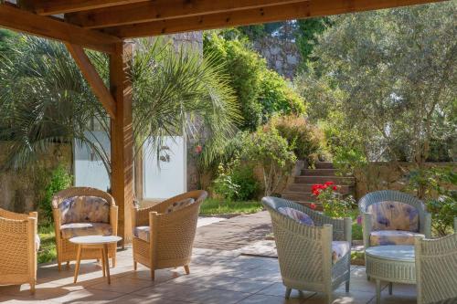 a group of chairs and tables on a patio at Best Western Plus San Damianu in Sartène