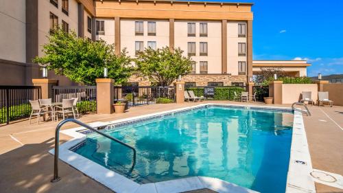 a swimming pool in front of a building at Best Western Plus Wichita West Airport Inn in Wichita