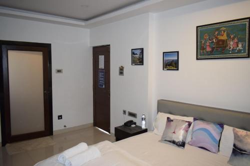 a bedroom with a bed with a picture on the wall at Athi Resorts in Bogmolo