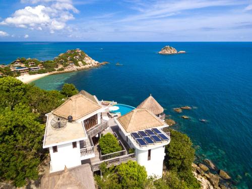an aerial view of a house on a hill overlooking the ocean at Villas Sabai Jai in Koh Tao