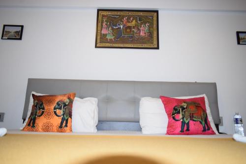 a shelf with pillows on top of a bed at Athi Resorts in Bogmolo