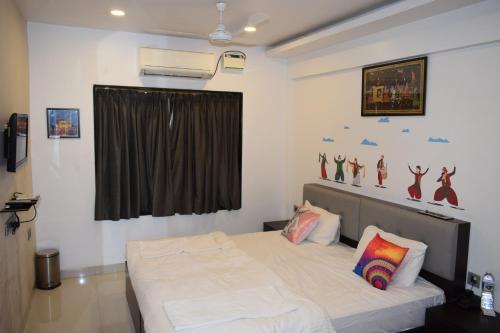 a bedroom with a bed with a curtain and a window at Athi Resorts in Bogmolo