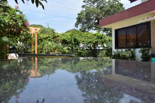 a swimming pool in front of a house at Athi Resorts in Bogmolo