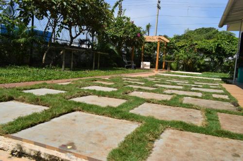 a garden with grass and stones in a yard at Athi Resorts in Bogmolo
