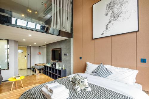 a bedroom with a bed and a living room at Lavendar Duplex Apartment in Guangzhou
