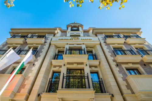 a building with a clock on top of it at Residence City Garden - Certificate of Excellence Top 10 BEST Five-Stars City Hotels for 2024 awarded by HTIF in Plovdiv