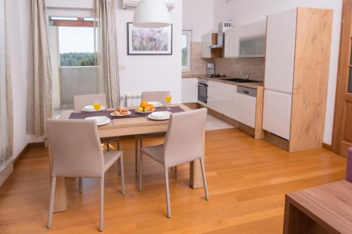 a kitchen and dining room with a table and chairs at Villa Lumare - 100m from the sea in Pula