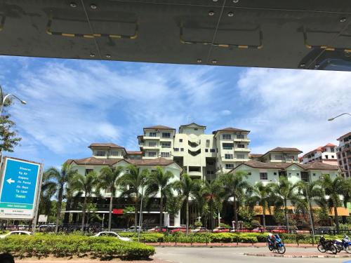 a view of a city with palm trees and buildings at Nusantara Mattwaddien Hostel in Kota Kinabalu