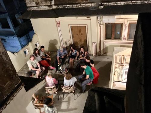 a group of people sitting in chairs in a room at Jaipur Haveli in Jaipur