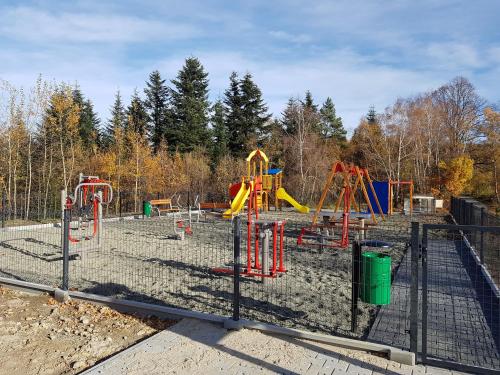 a playground in the dirt with a play yard at Gniewnik in Pcim