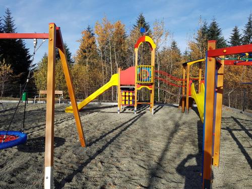 a playground with a yellow and red slide at Gniewnik in Pcim