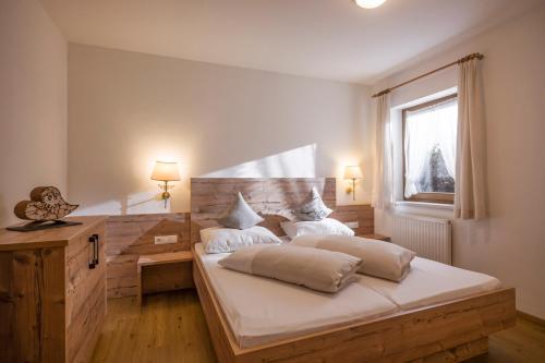 a bedroom with a large bed with a wooden headboard at Apart Heim in Fügen