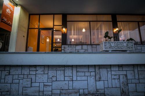 a building with a bench in front of a window at The Holy Rock - Hostel at meteora in Kalabaka