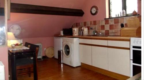 a kitchen with a washing machine in a kitchen at Shirley Lane in Ashbourne