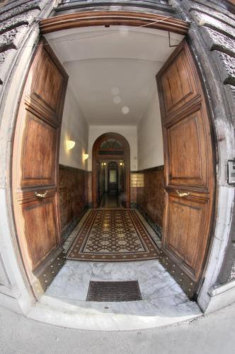 an empty hallway with wooden doors in a building at Nakissa Inn in Rome