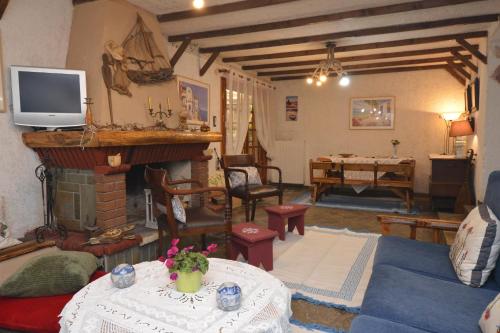 a living room with a fireplace and a tv at House with Big Garden in Korinthos