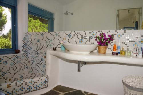a bathroom with a sink and a mirror at Villa in Marathonos in Schinias