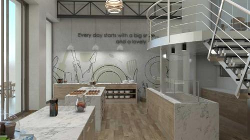 a kitchen with a staircase and a wall with graffiti at Hotel Avra by Smile hotels - Free Airport Shuttle in Rafina