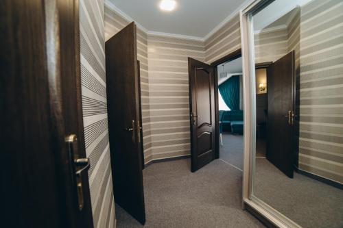 a corridor of a hotel room with a mirror at Globus Hotel in Ternopilʼ
