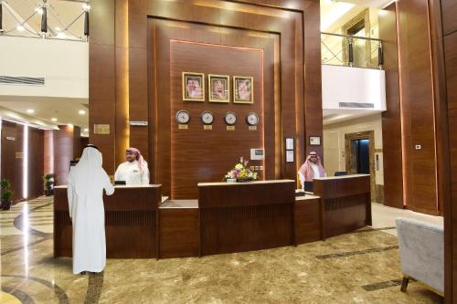 a nun standing in the lobby of a hotel at Zaha Al Munawara Hotel in Al Madinah