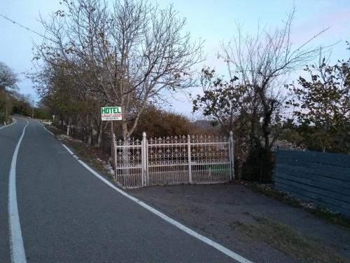 a gate on the side of a road with a sign at Guest House Guliada in Gordi