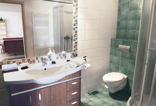 a bathroom with a sink and a toilet at blueline guesthouse in Áyios Dhimítrios