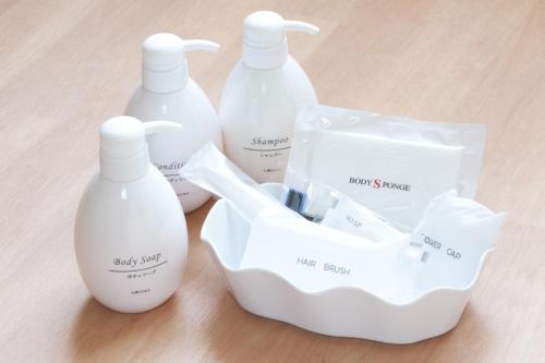 a group of three white bottles sitting on a table at Hotel Kudou Oita in Oita