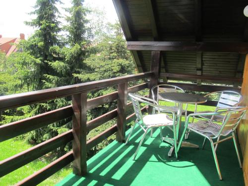 a porch with two chairs and a table at Apartments Zlatibor's Peace in Zlatibor