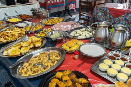 a table with many different types of food on it at Hotel Pousada da Praia in Recife